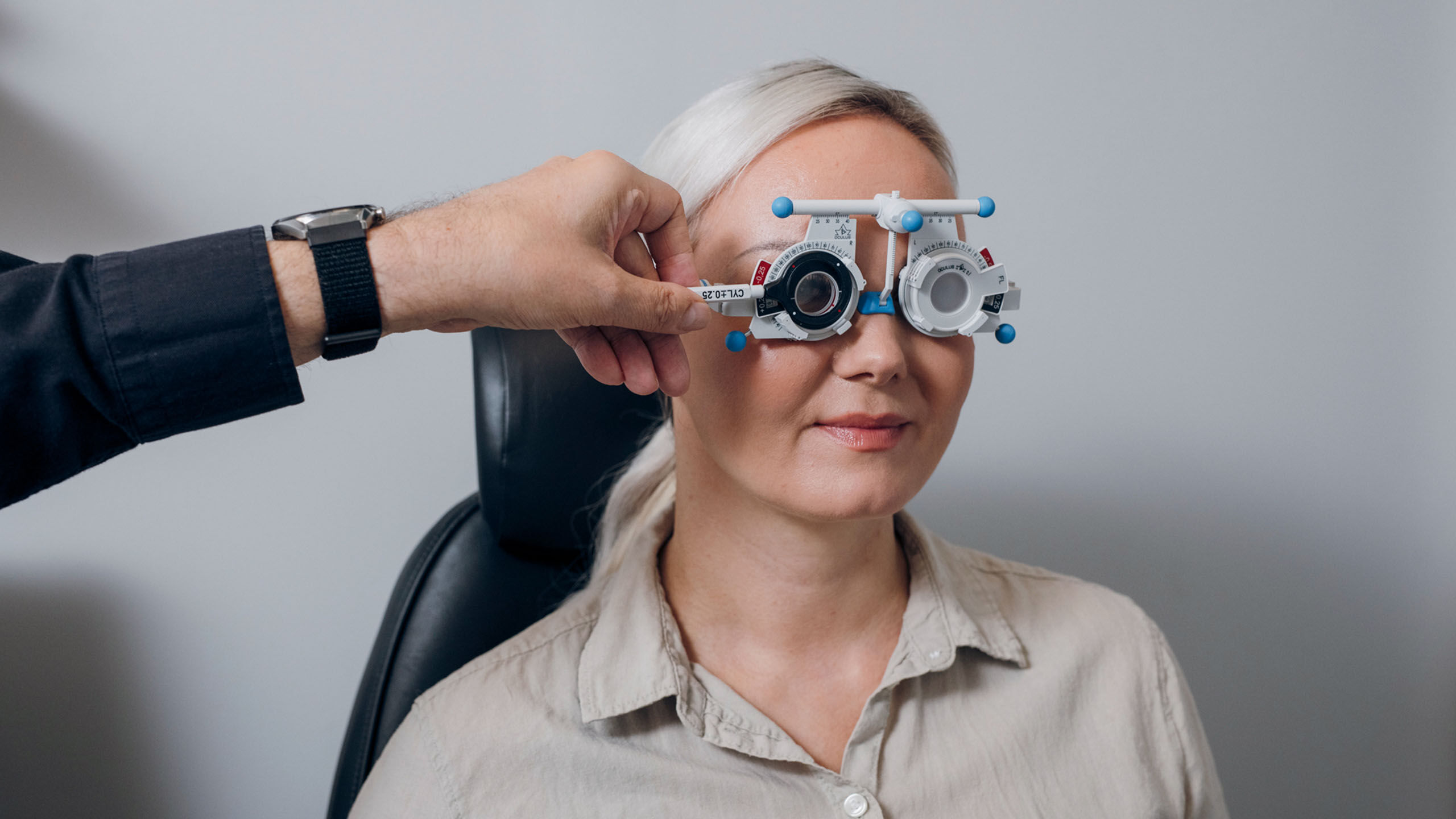 Optikko suorittaa näöntutkimusta asiakkaalle